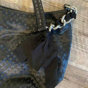 Simply Vera by Vera Wang black purse with chain on strap and ribbon.